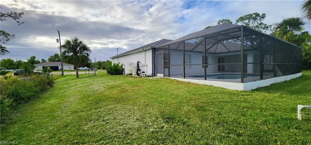 View of yard with a lanai
