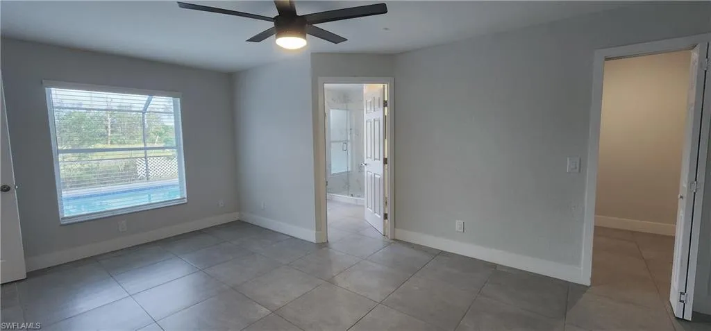 Spare room with light tile patterned floors and ceiling fan