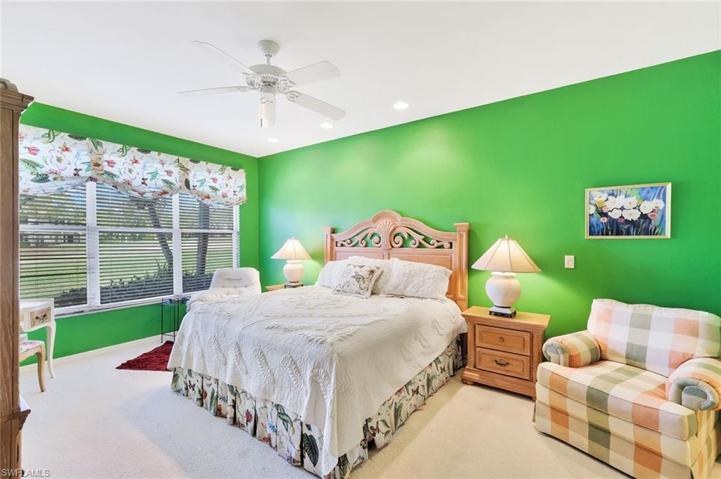 Large primary bedroom suite with golf course view.