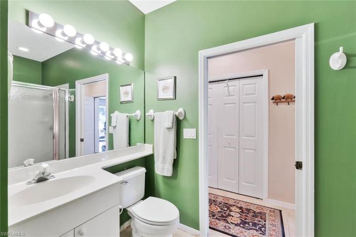En suite guest bathroom with a pocket door to the main living area.