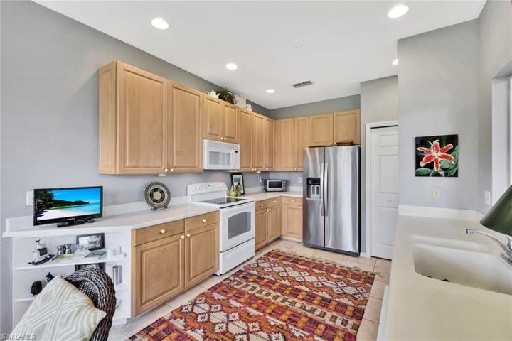 Kitchen offers ample cabinet space and a pantry.