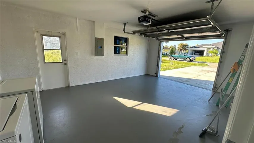 Empty room featuring light tile patterned flooring and a ceiling fan