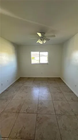 Laundry area with a textured wall, separate washer and dryer, electric panel, and a garage