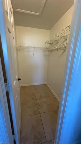 Bathroom featuring vanity, a shower stall, and light tile patterned flooring