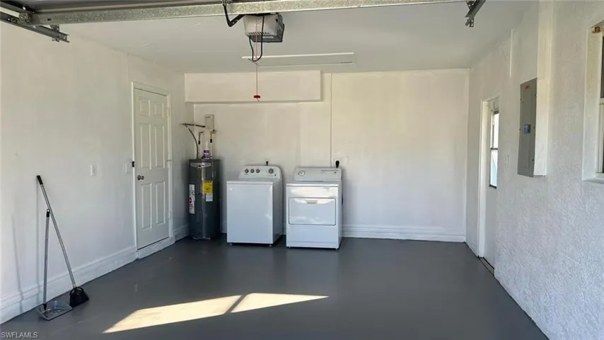 Unfurnished bedroom featuring a walk in closet, tile patterned floors, a ceiling fan, and ensuite bathroom