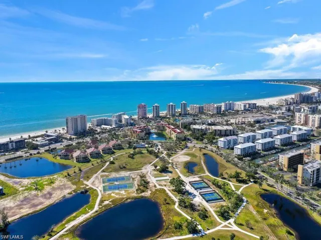 Birds eye view of property with a water view