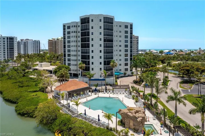View of swimming pool with a water view and a patio