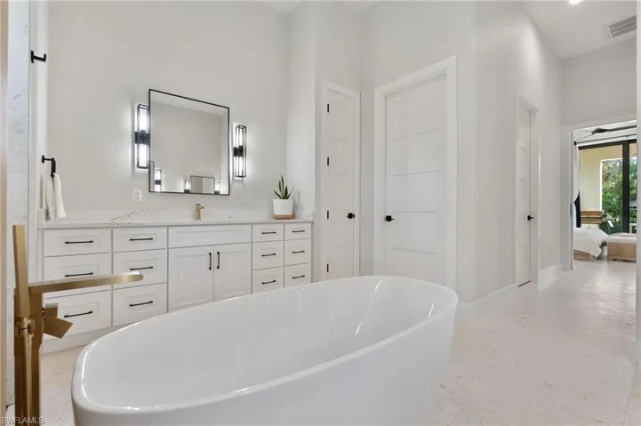Bathroom with vanity and a tub to relax in