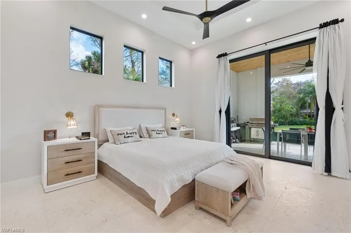 Bedroom featuring multiple windows, access to outside, and ceiling fan