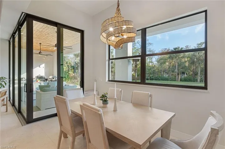 Dining space featuring light tile patterned floors and a chandelier