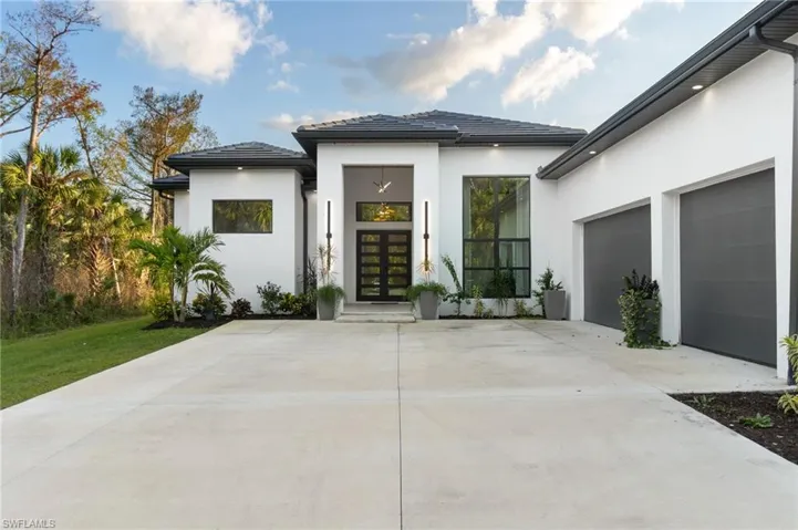 Front of house featuring a garage and french doors
