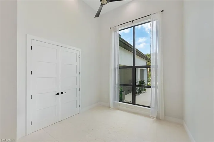 Unfurnished bedroom featuring ceiling fan and a closet