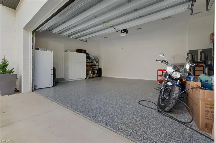 Garage with a garage door opener and fridge