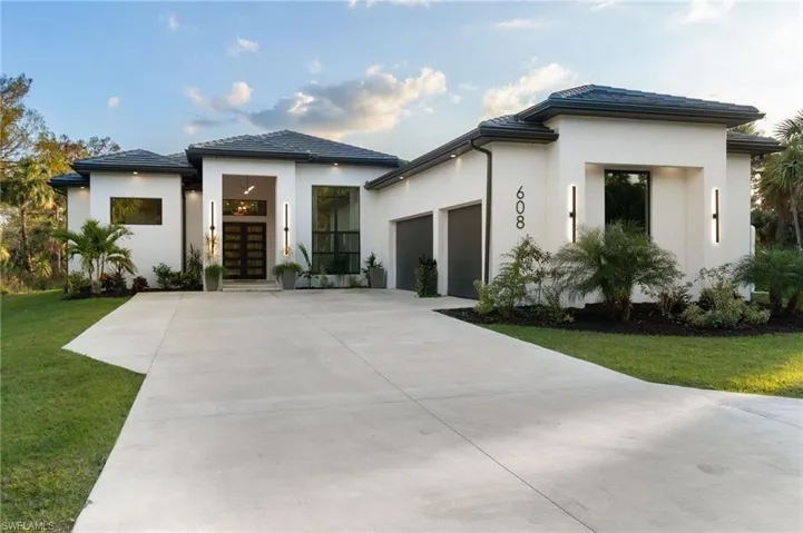 View of front of house featuring a garage and a front yard