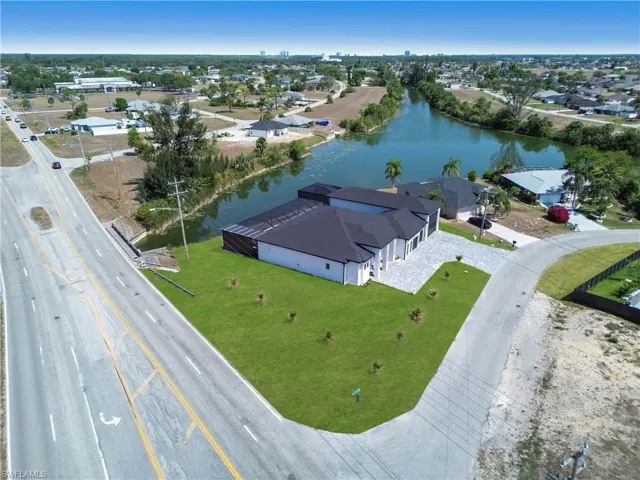 Drone / aerial view with a residential view and a water view