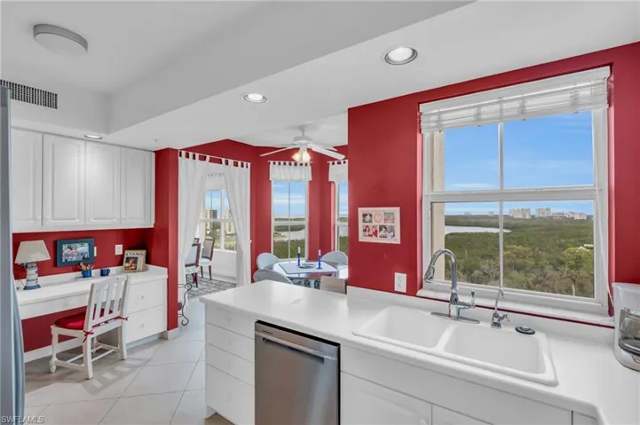 Kitchen featuring a healthy amount of sunlight, white cabinetry, and stainless steel dishwasher