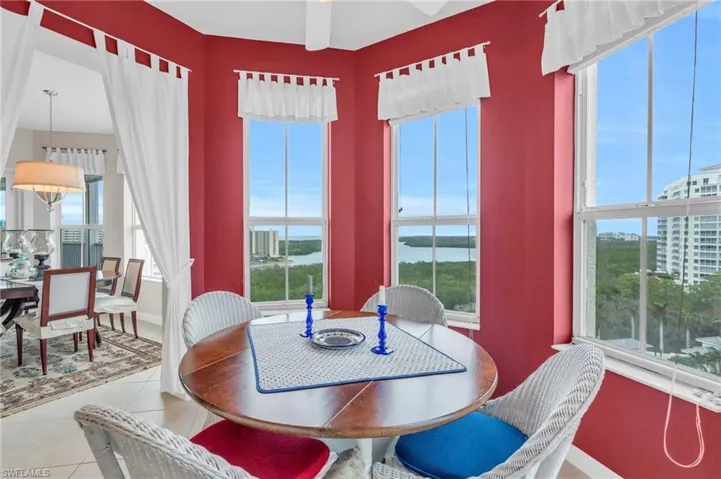 Dining space with light tile patterned floors, a water view, and plenty of natural light