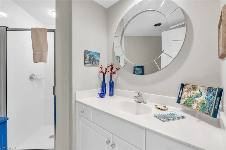 Bathroom featuring vanity and an enclosed shower