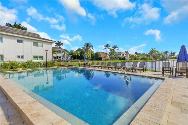 Community pool featuring a patio and a residential view