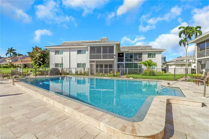 Community pool featuring a patio and a sunroom