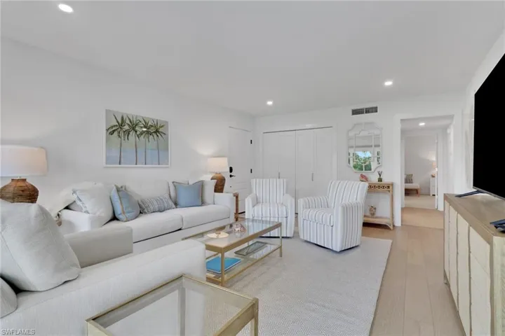 Living area with recessed lighting and light wood-type flooring