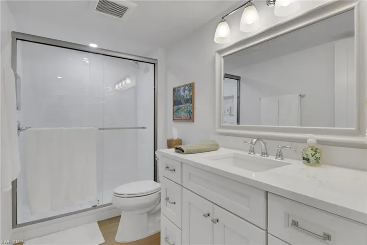 Bathroom with a stall shower, vanity, and light tile patterned floors