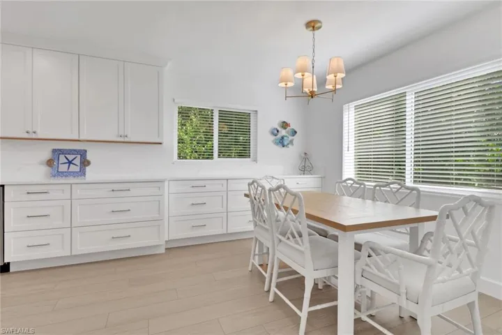 Dining room with light wood-style flooring and a chandelier