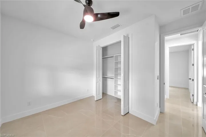Unfurnished bedroom featuring ceiling fan and a closet