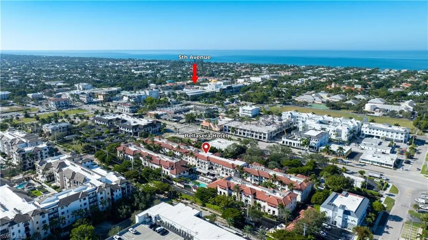Aerial view of property's location featuring nearby urban area and a nearby body of water