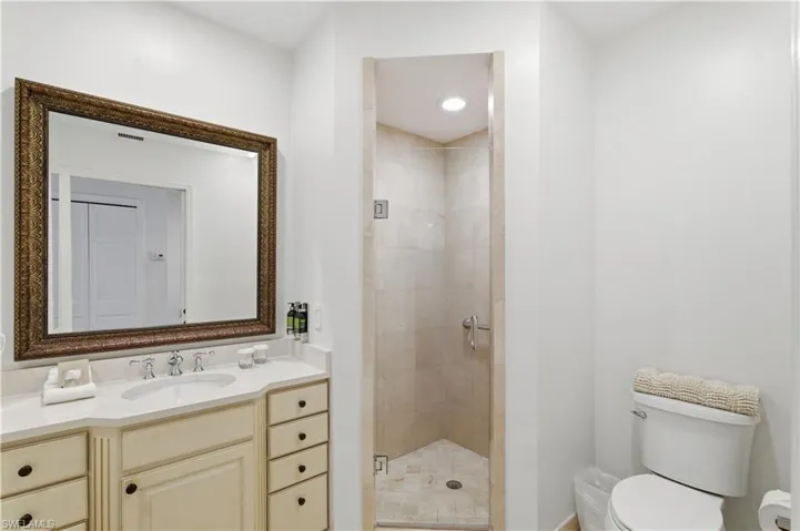 Bathroom with a stall shower and vanity