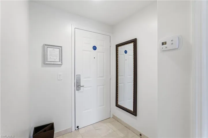Doorway featuring baseboards