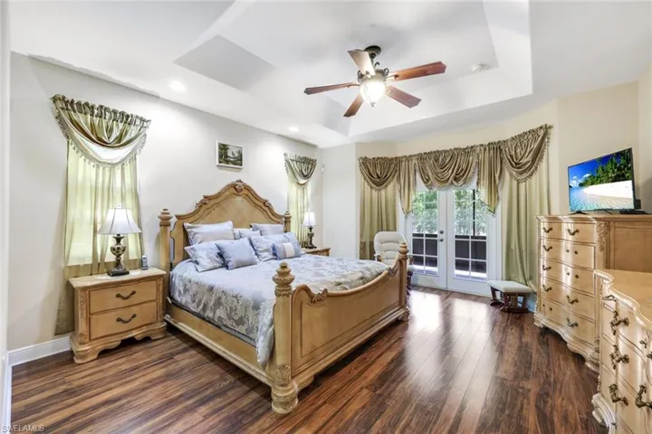 Master bedroom with french doors and wood flooring