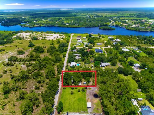 View of property location with a nearby body of water and property boundaries highlighted