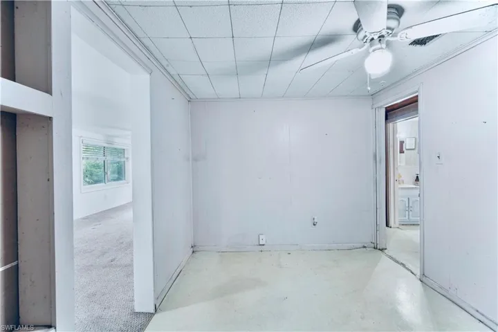 Unfurnished room with ceiling fan and concrete floors