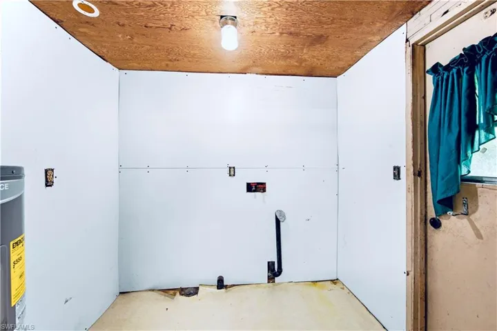 Laundry area featuring water heater
