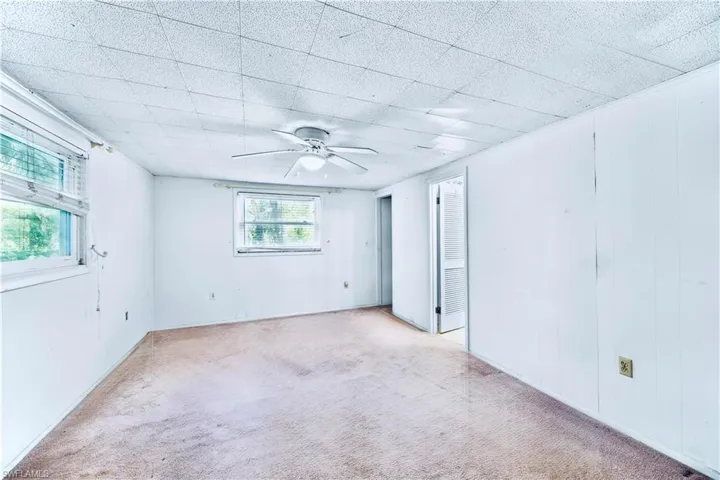 Unfurnished bedroom featuring carpet floors and ceiling fan
