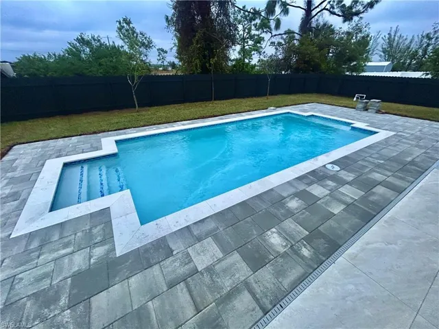 View of pool with a yard and a patio