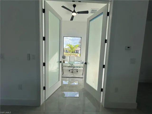 Hallway featuring light tile patterned flooring