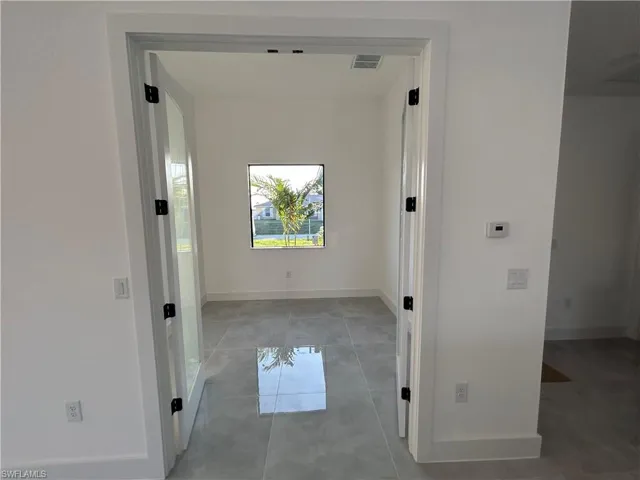 Hallway with light tile patterned floors