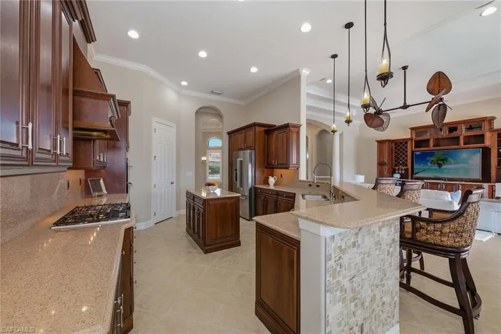 Gas KitchenAid stainless steel appliances. Custom wood covered hood vented to outside