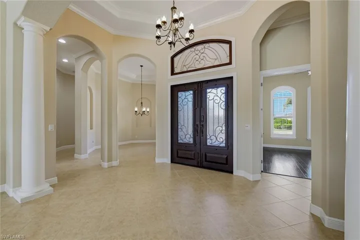 Grand entry with dual glass insert front doors and transom