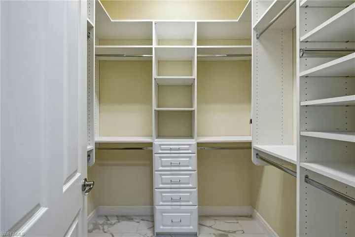 Primary Bedroom features two-walk in closets with custom shelving