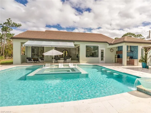 View of swimming pool featuring an outdoor hangout area, a patio, a pool with connected hot tub, and area for grilling