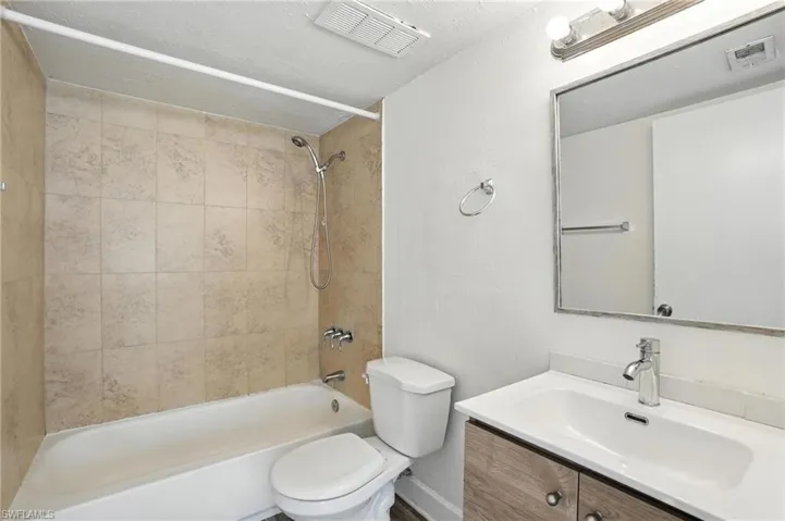 Full bath featuring shower / washtub combination and vanity