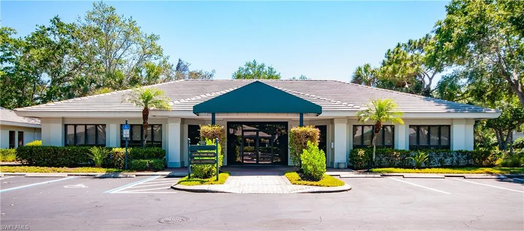 View of building exterior featuring uncovered parking