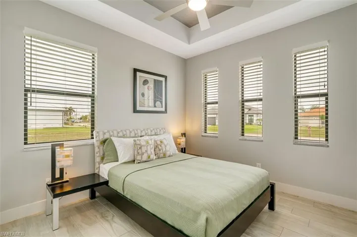 Bedroom with ceiling fan and loads of natural lighting