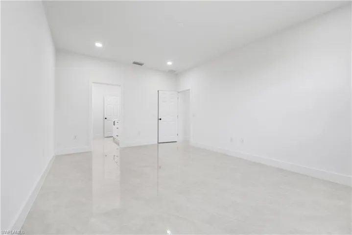 Empty room with light tile floors