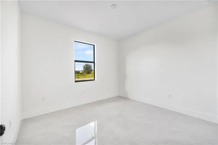 Empty room with light tile flooring