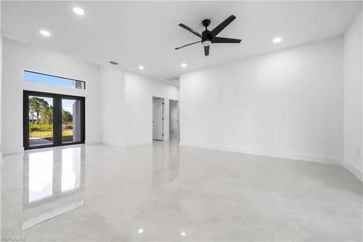 Spare room featuring french doors, ceiling fan, and light tile floors