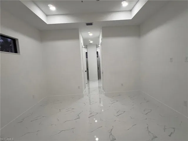 Spare room with a tray ceiling
